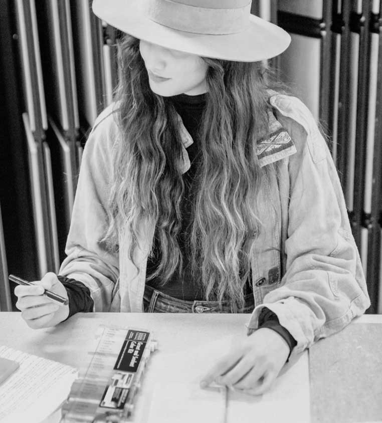 Woman drawing up designs on paper